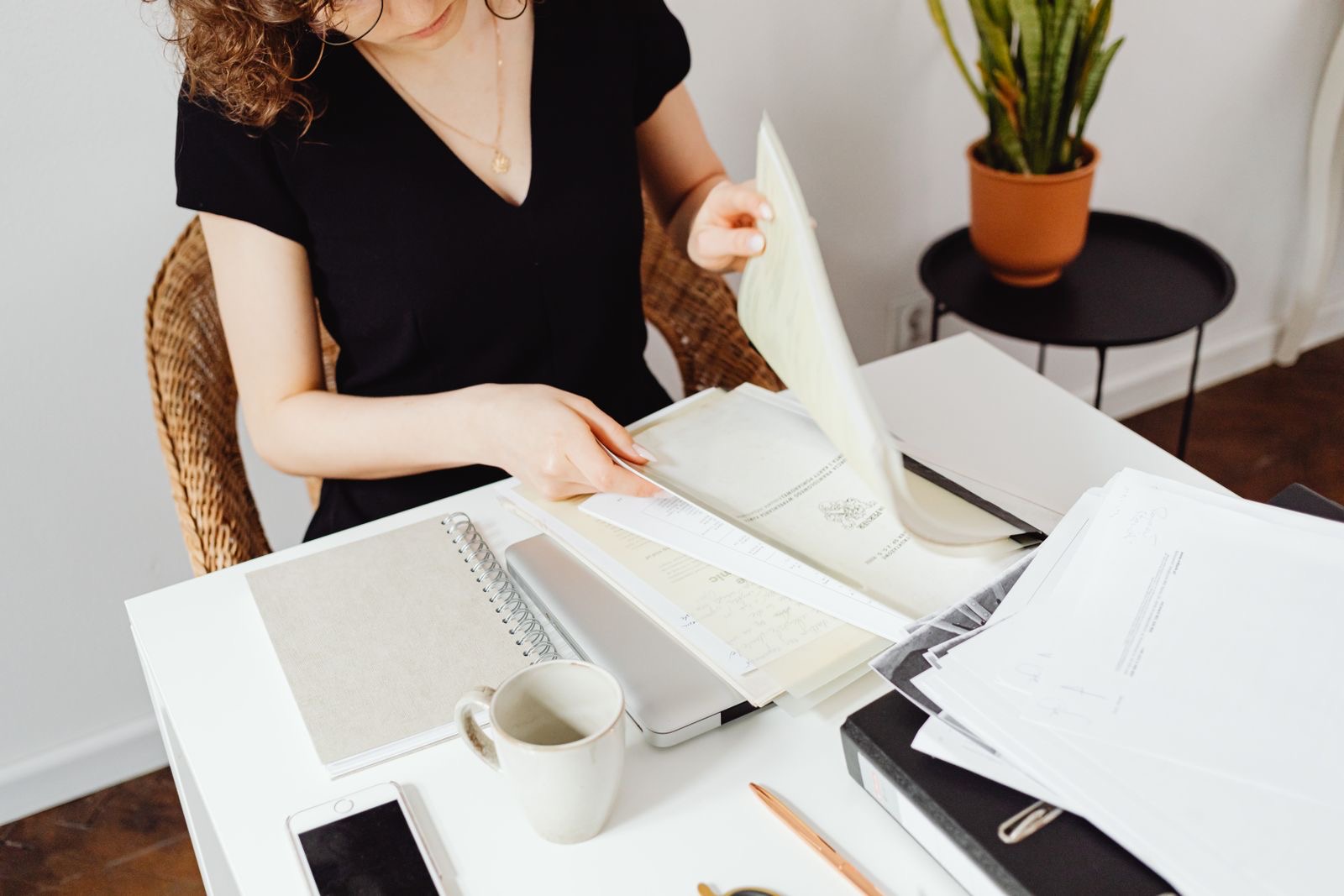 A person looking through documents at a desk
